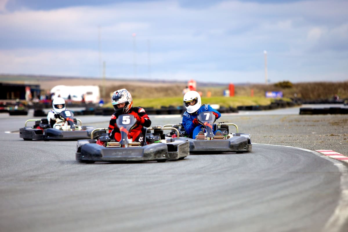 A man in a go kart racing around a track