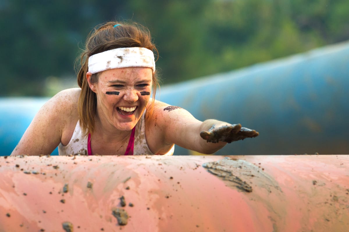 A woman having fun on an assault course