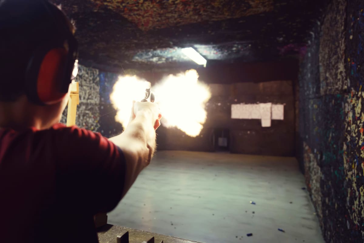 A man shoots a gun a shooting range