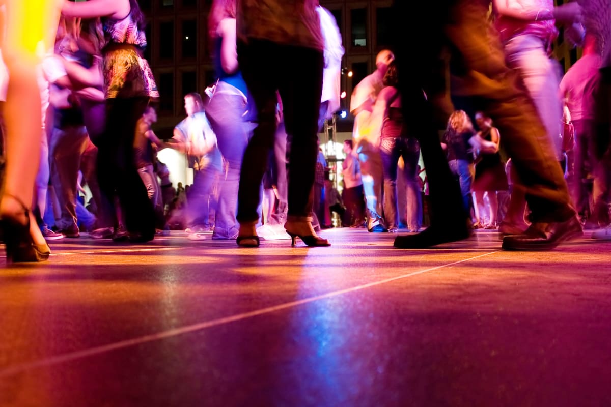 A group of people taking a salsa dancing lesson