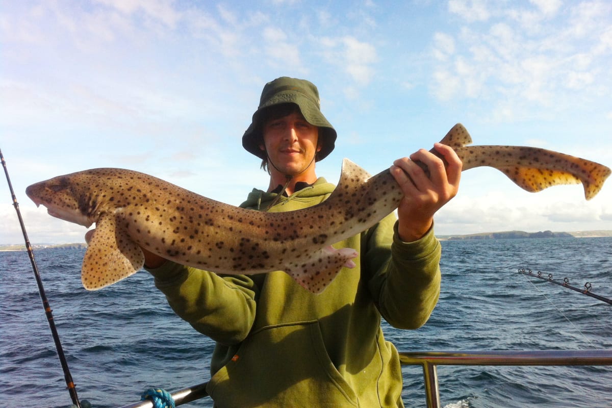 A man holding a big fish that he's caught