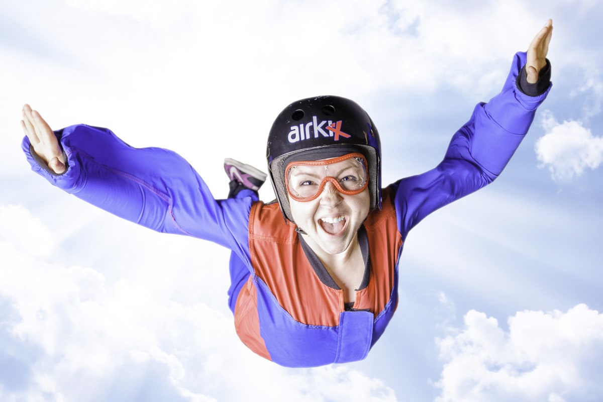 A woman doing indoor skydiving