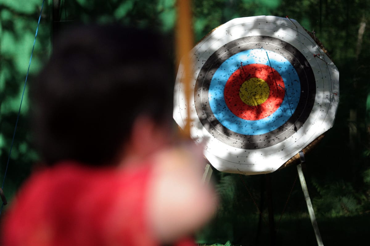 A man shooting an archery target