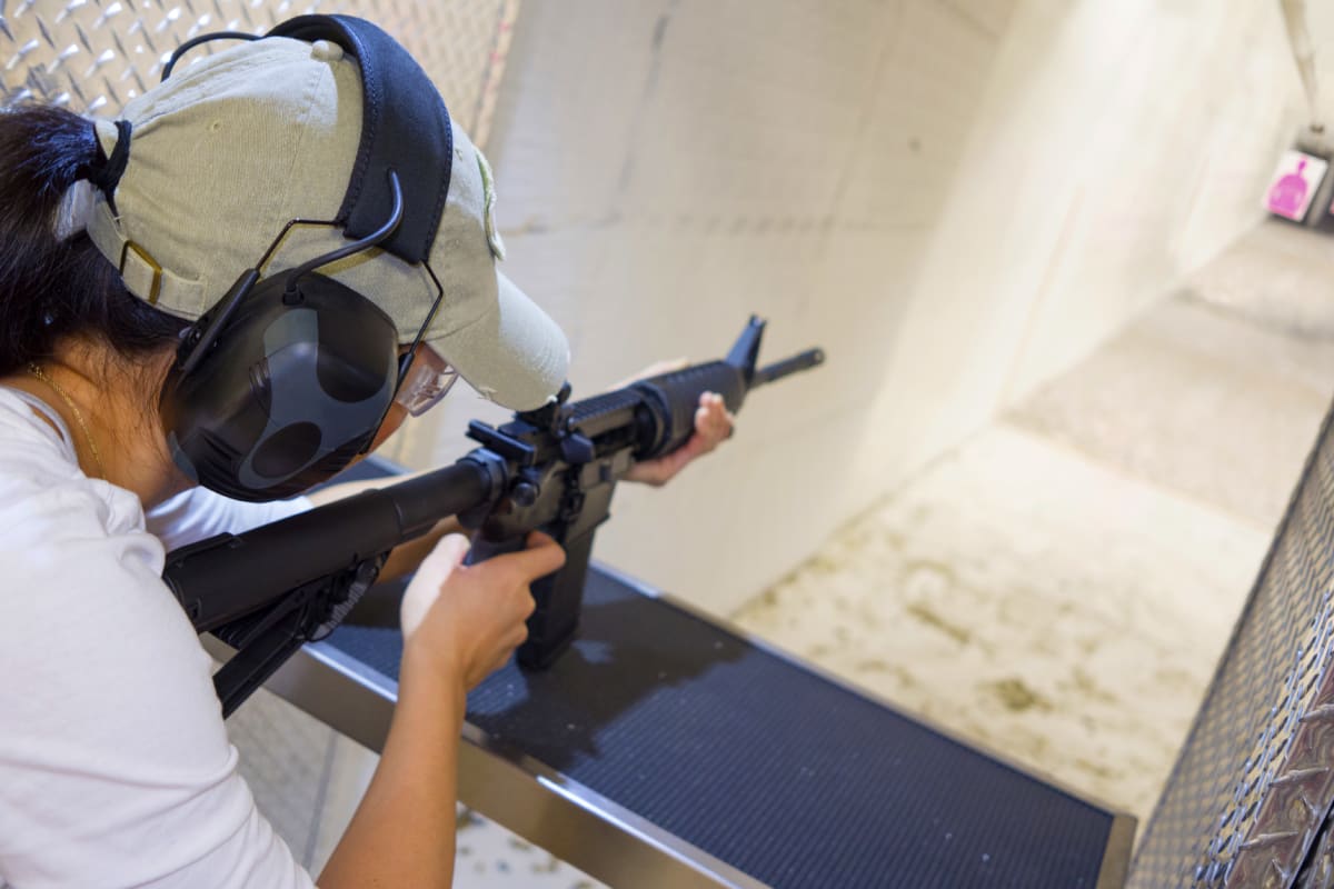 A woman on a Hen weekend target shooting