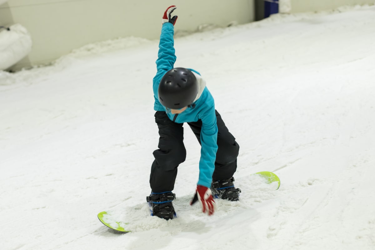 man snowboarding inside ski resort