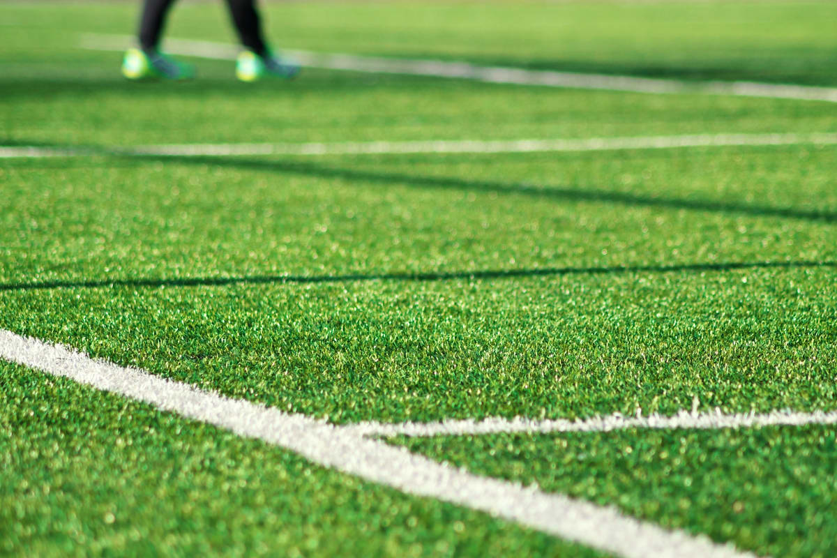 Sports field with artificial grass and white sports lines