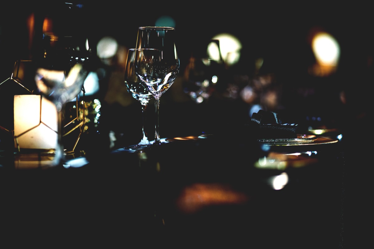 Dinner in the dark bokeh effect glasses dim lighting romantic feel