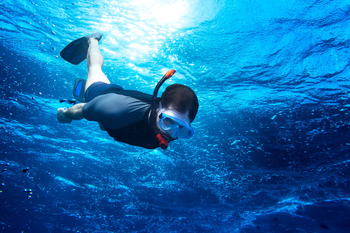 man snorkeling in ocean