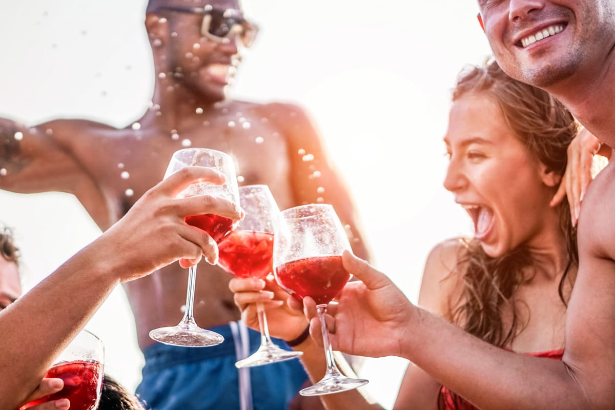 group of friends on boat drinking sangria enjoying sunshine