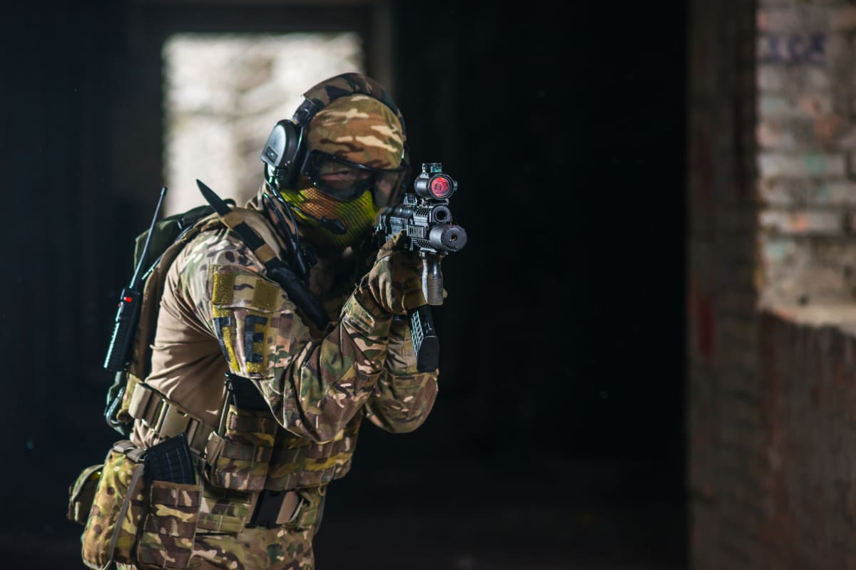 man playing airsoft inside venue