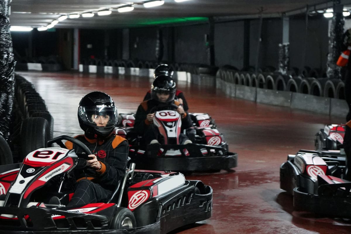 mixed group doing indoor go karting chilli