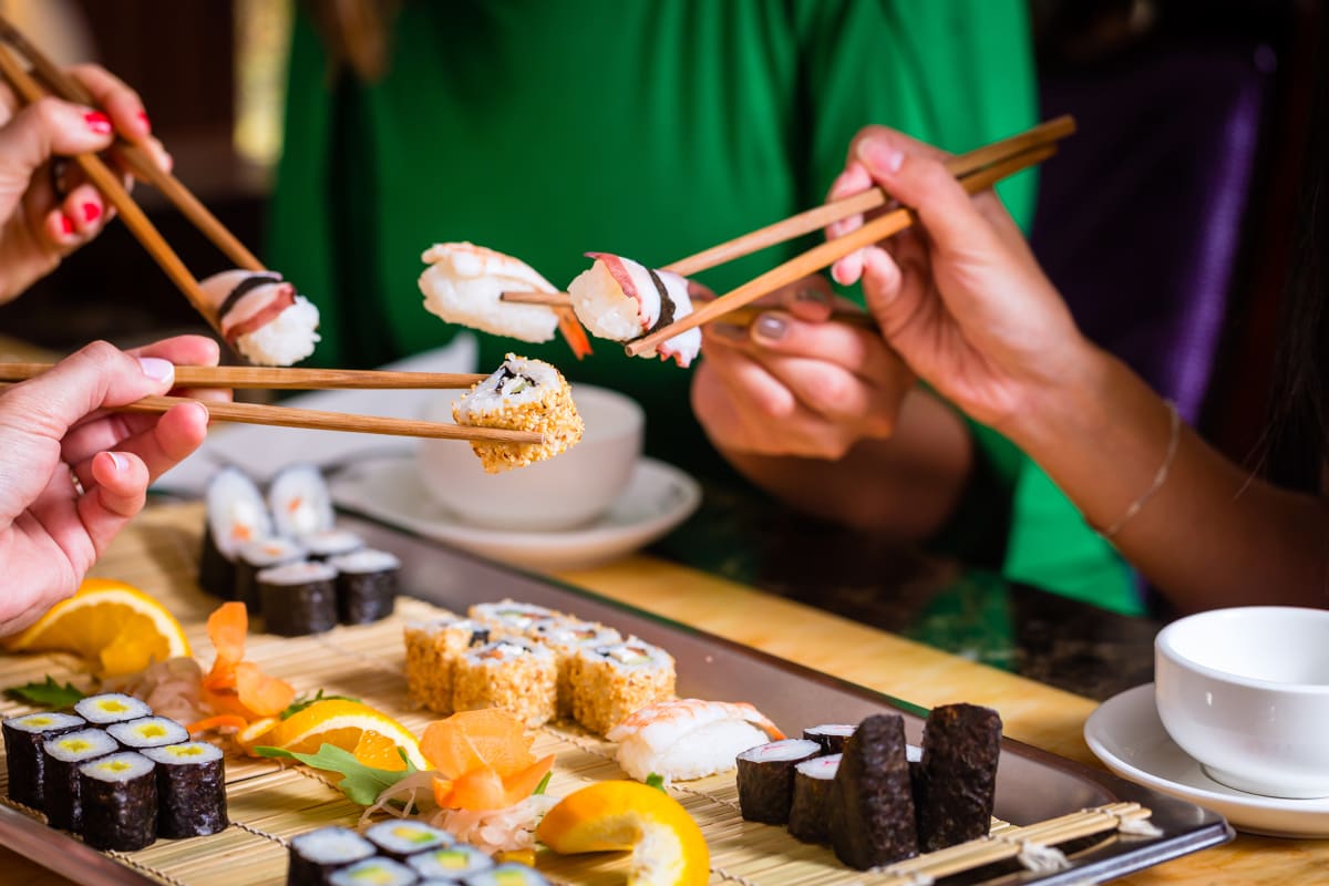 friends enjoying sushi together