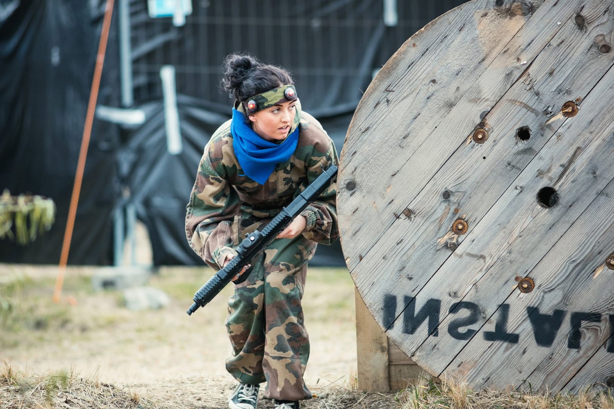 A woman playing airsoft