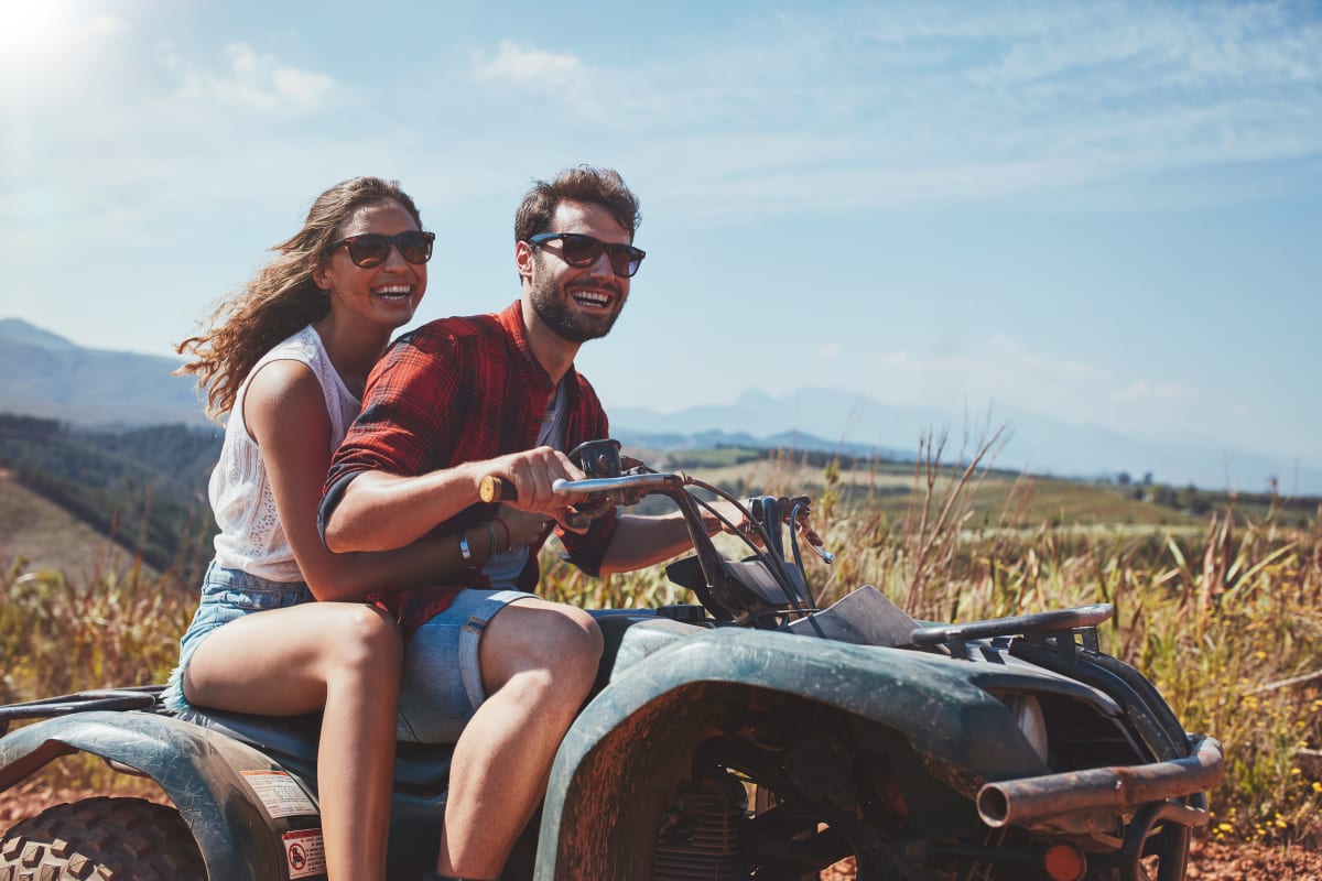 man and woman on quad bike