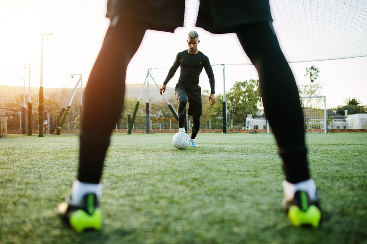 two men playing five aside football