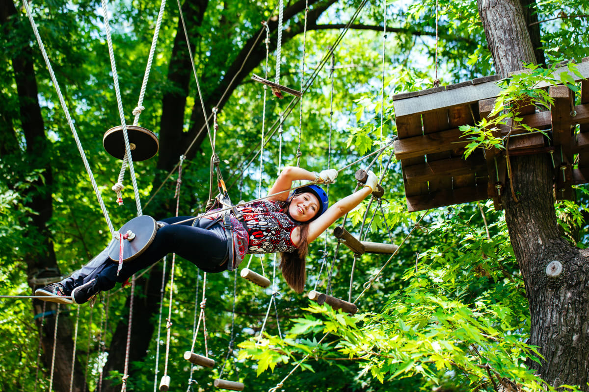 A woman having fun on a high ropes course