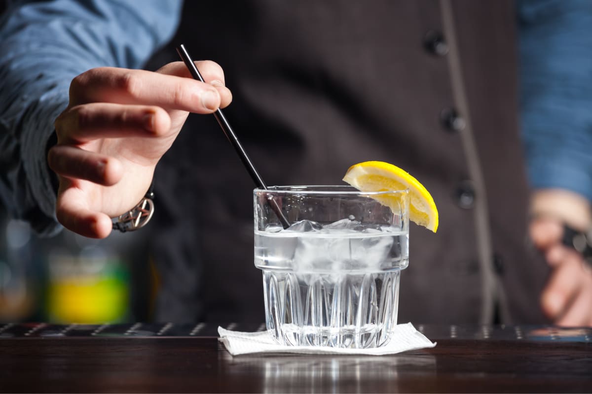 man serving gin drink