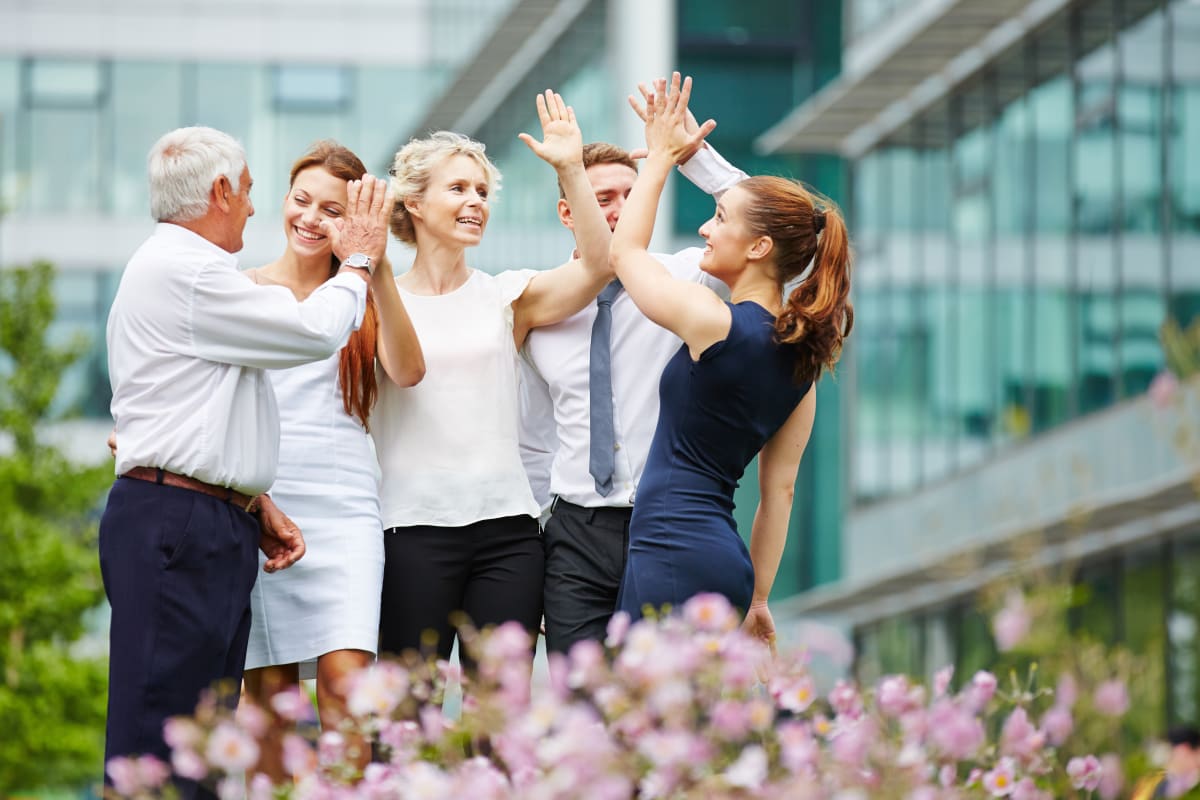 corporate laughing high five outside