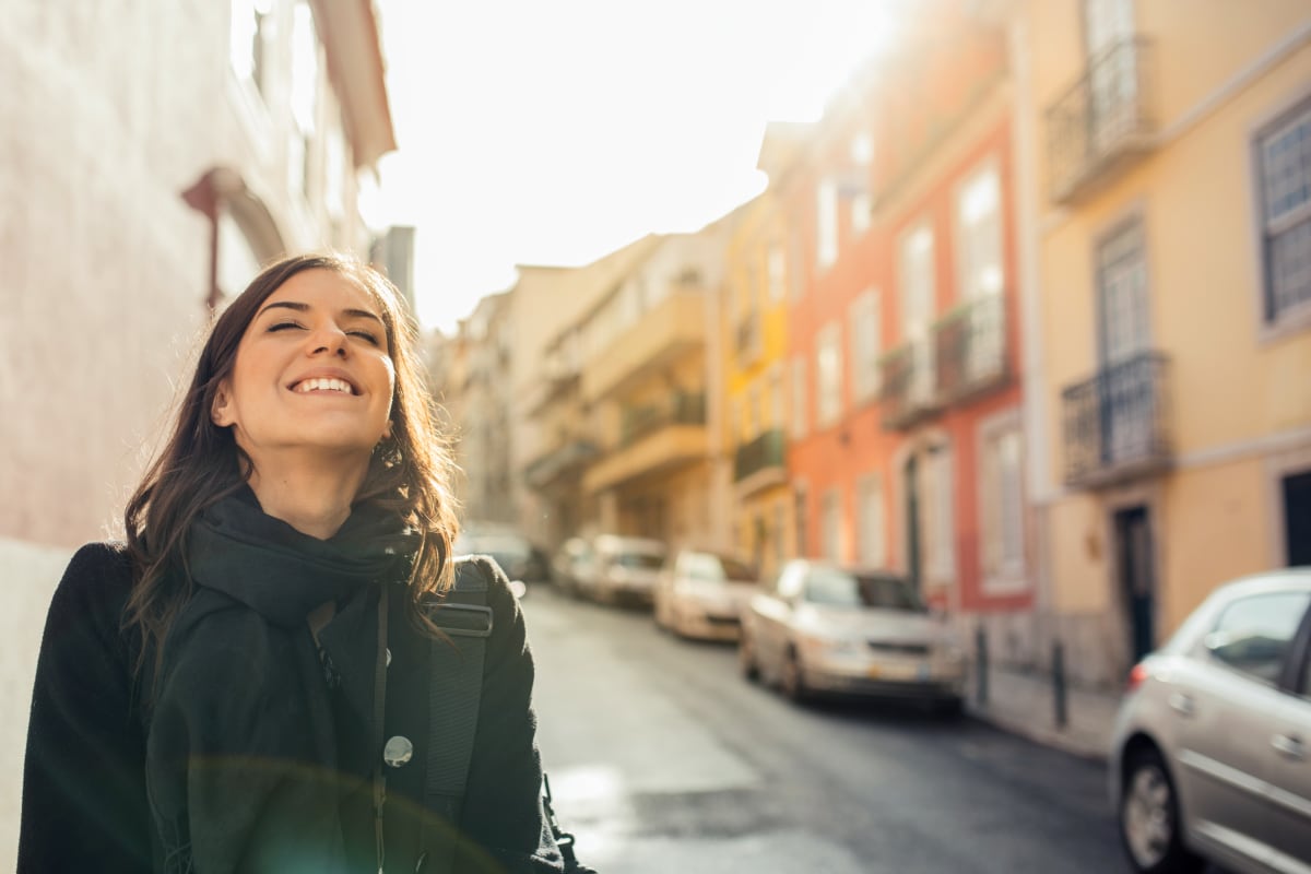woman smiling in streets of lisbon