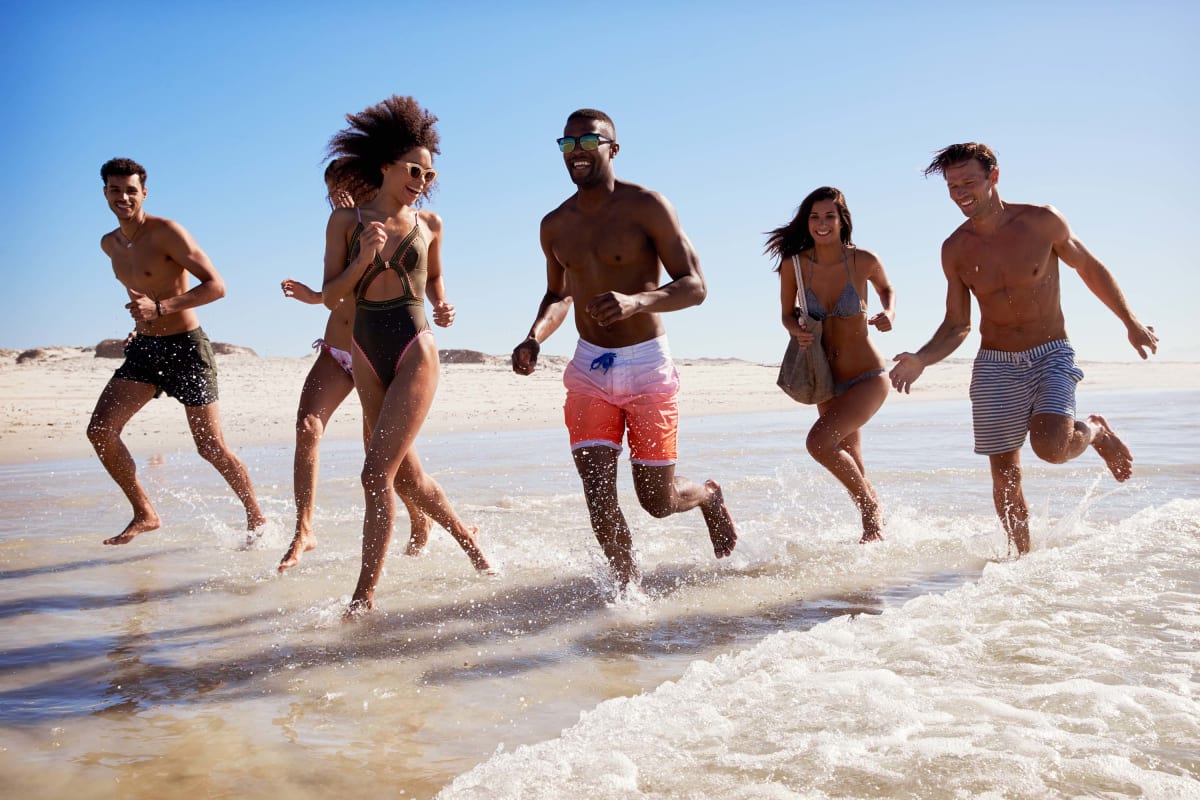 People Group running on the Beach Team Building