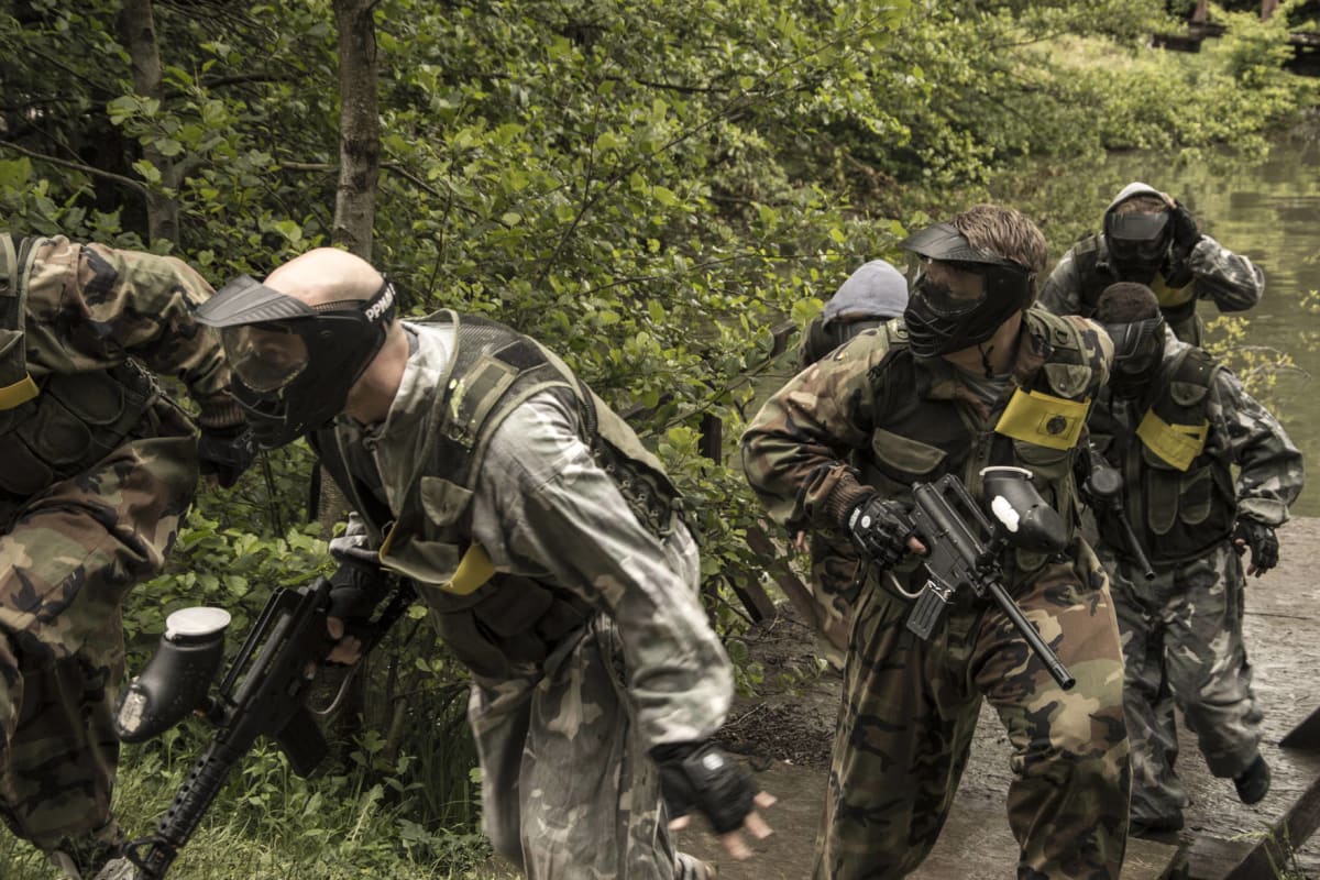 A group of men playing paintball