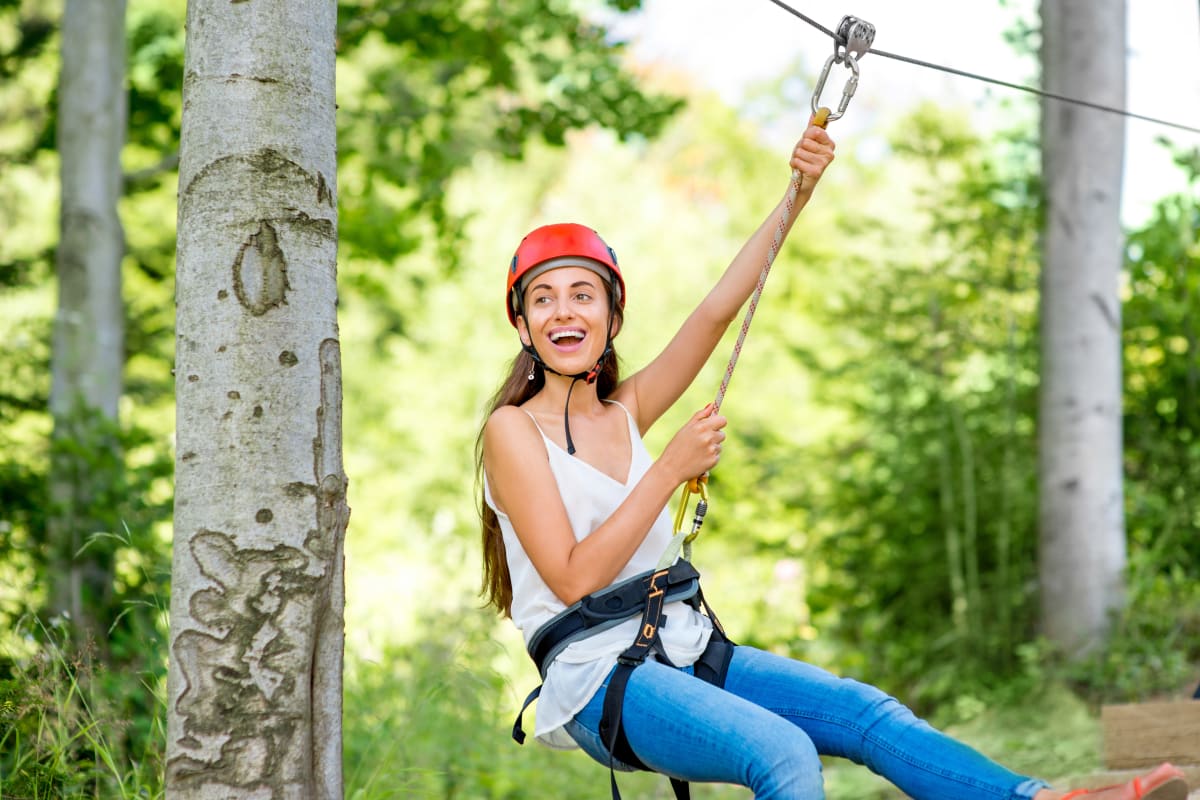 A woman having fun on a high ropes course