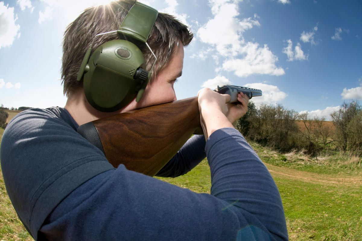 A man shoots clay pigeons