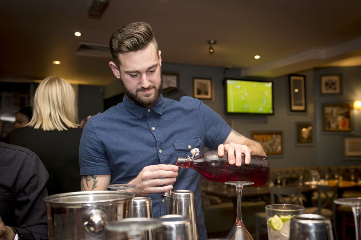 A group of men enjoying a stag party cocktail making