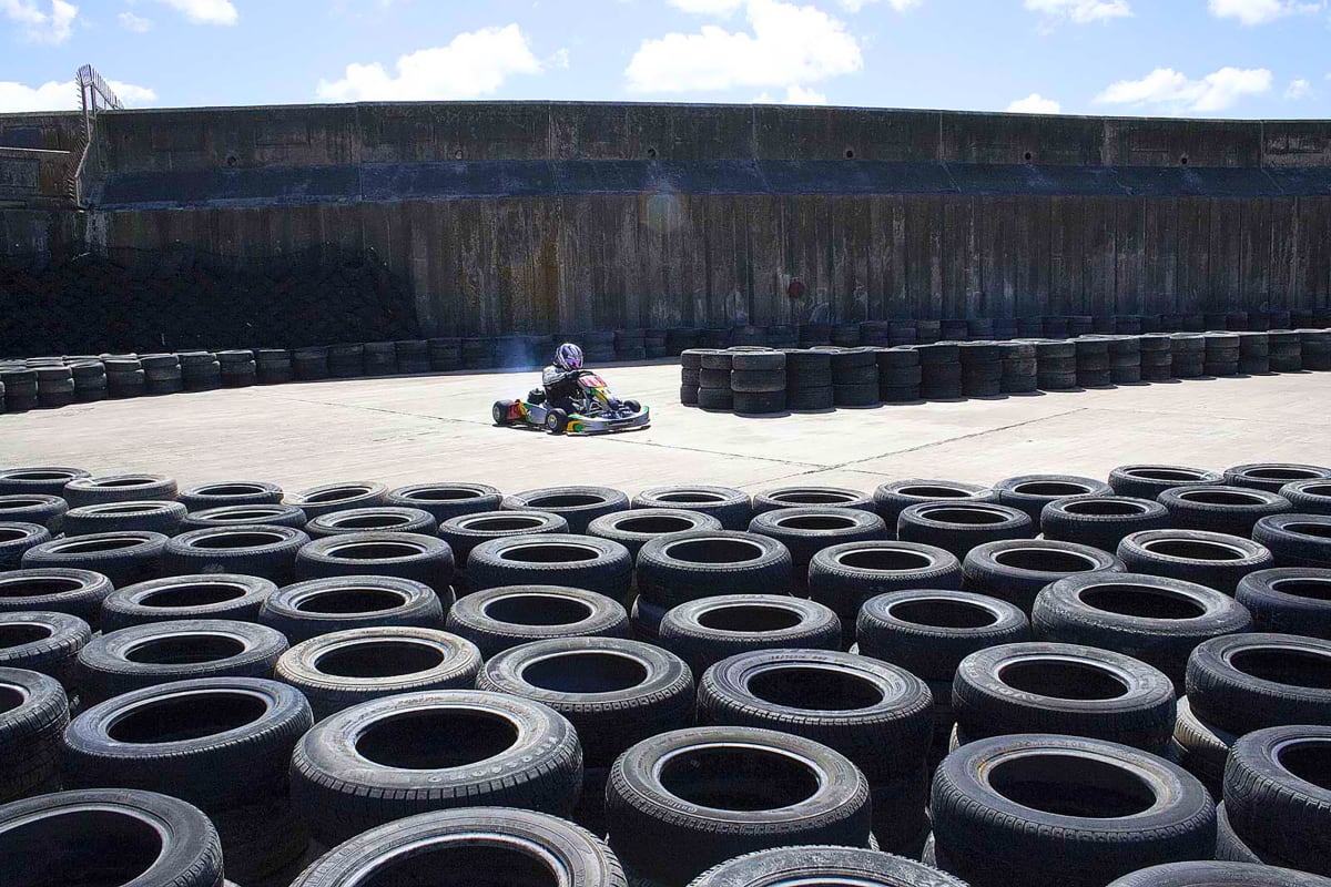 A driver races around a go karting track