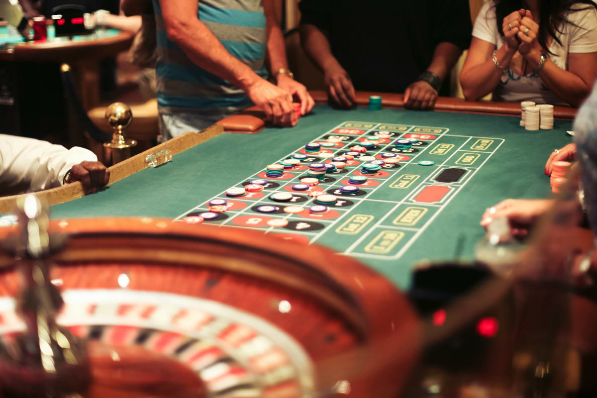 Group playing blackjack at the casino table