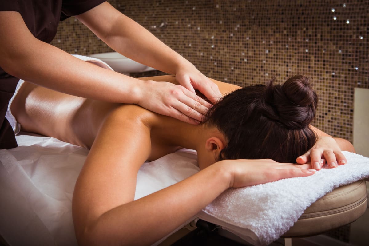 a woman receiving a massage during pampering session