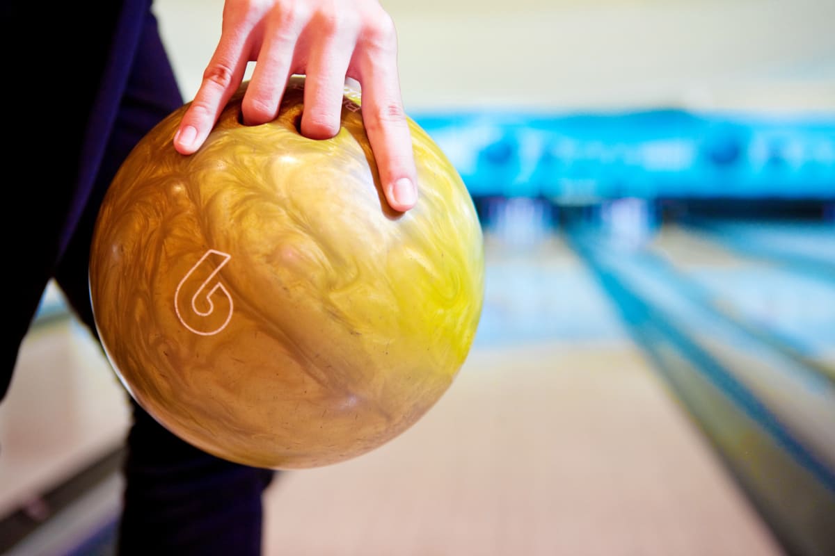A person holding a bowling ball