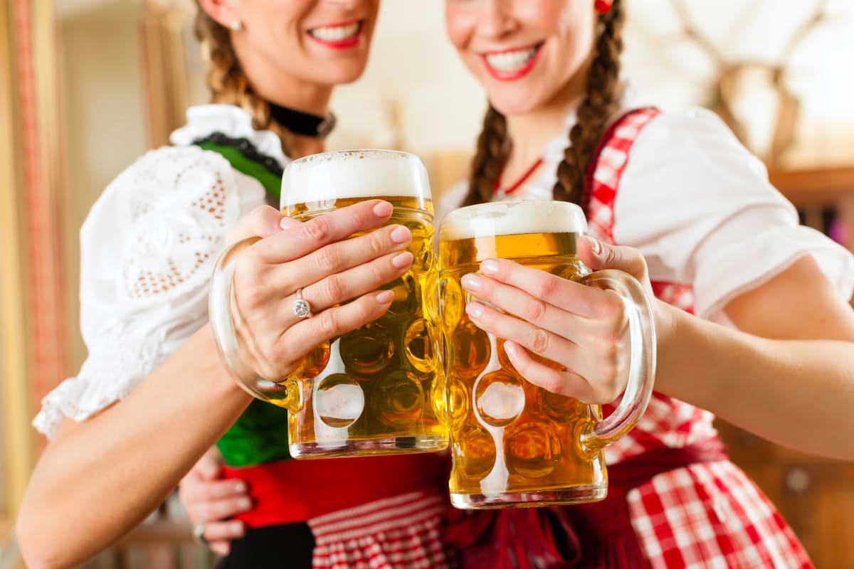 Two women drinking beers in a Bavarian beer house