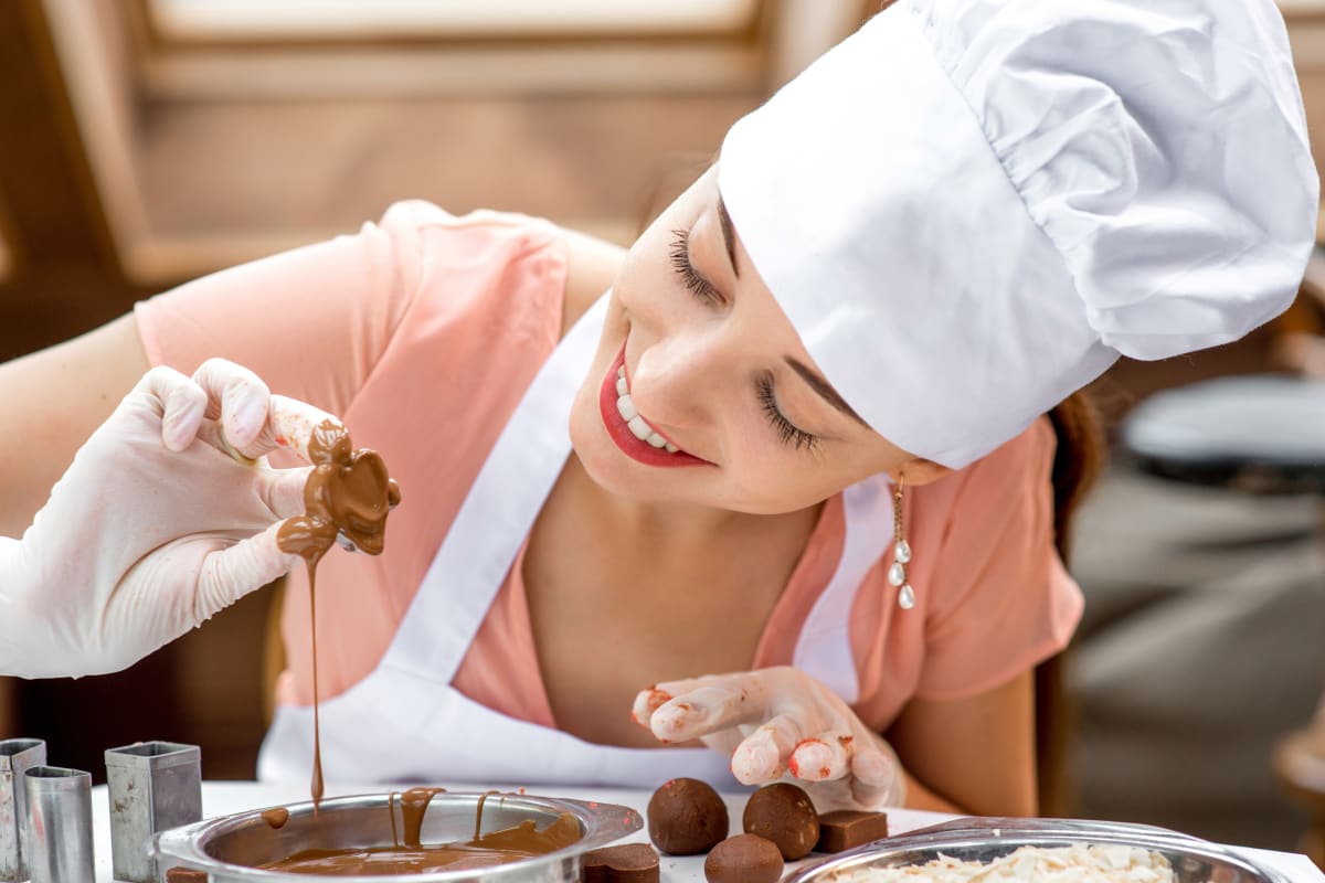 A woman making chocolates