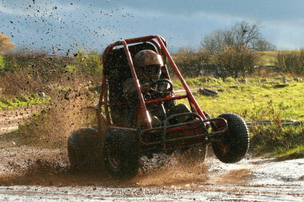 A Gemini Liberator off road kart on a muddy off road course
