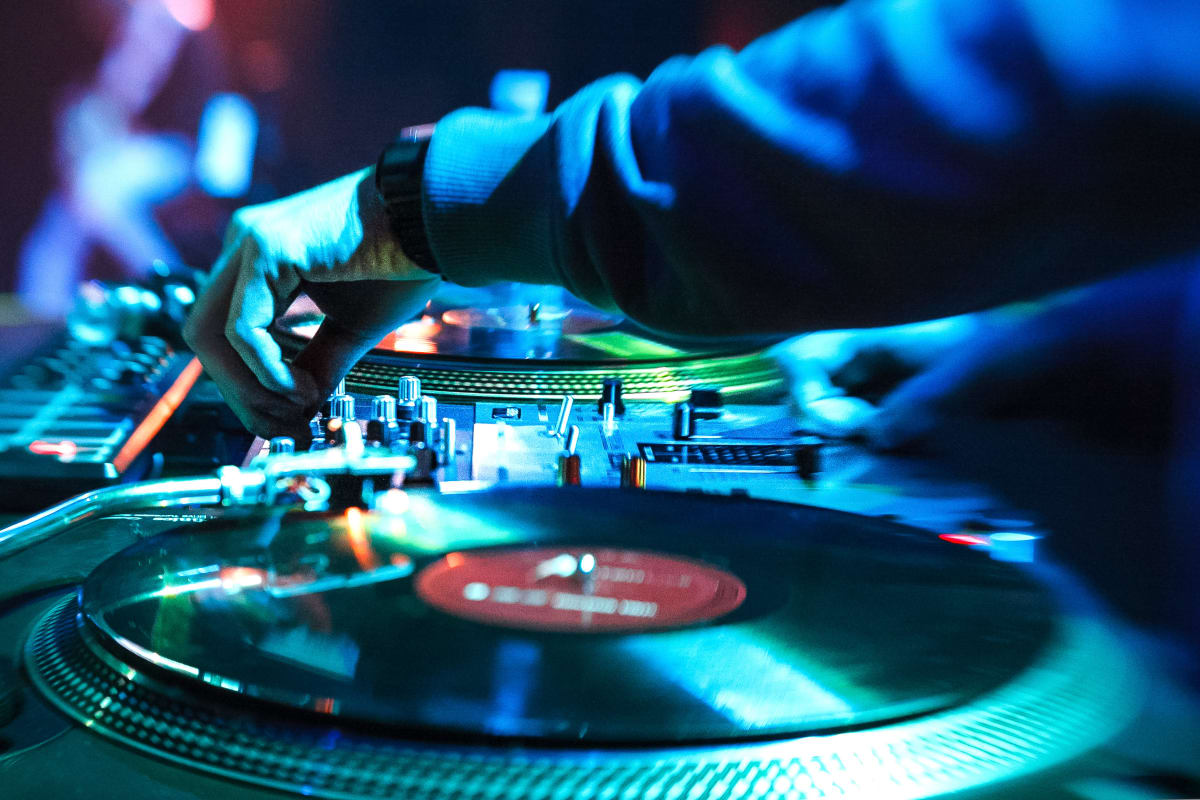 A dj plays in a nightclub party