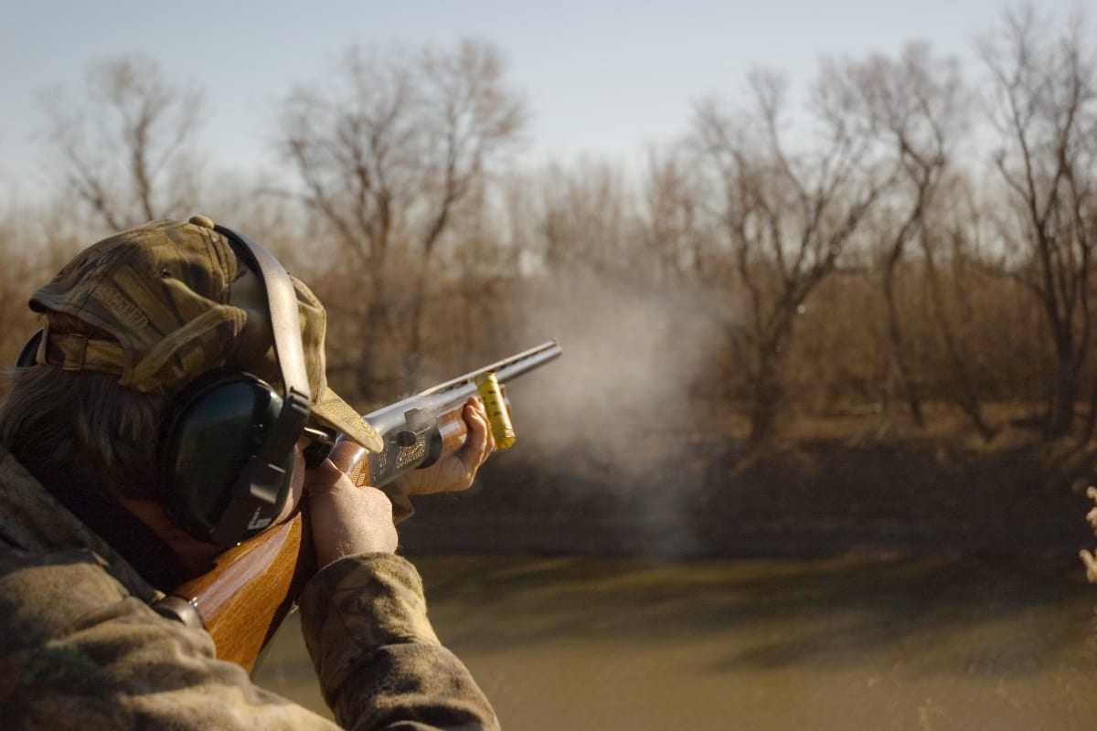 a man shoots during clay pigeon shooting