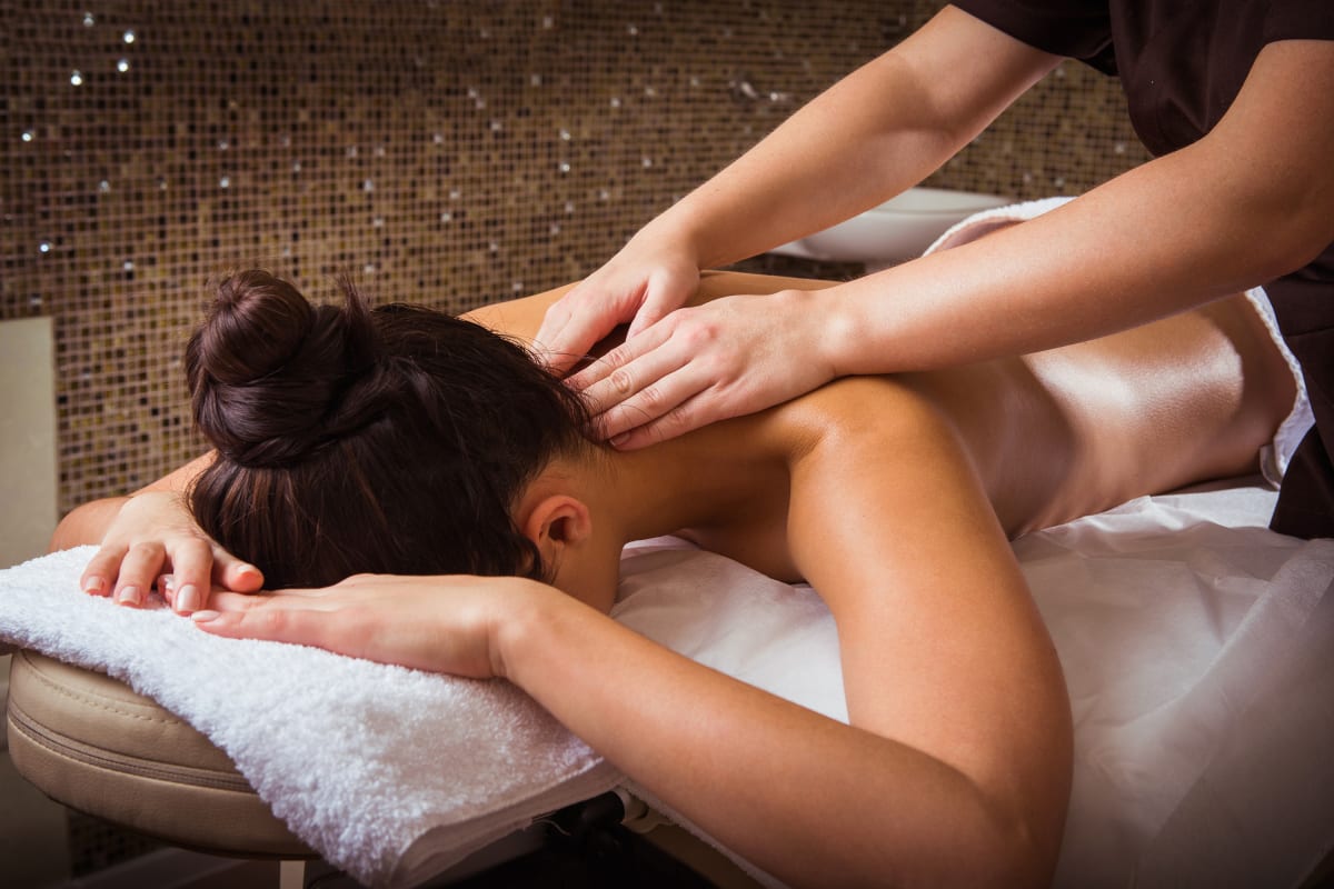 A woman receives a massage during a pampering session