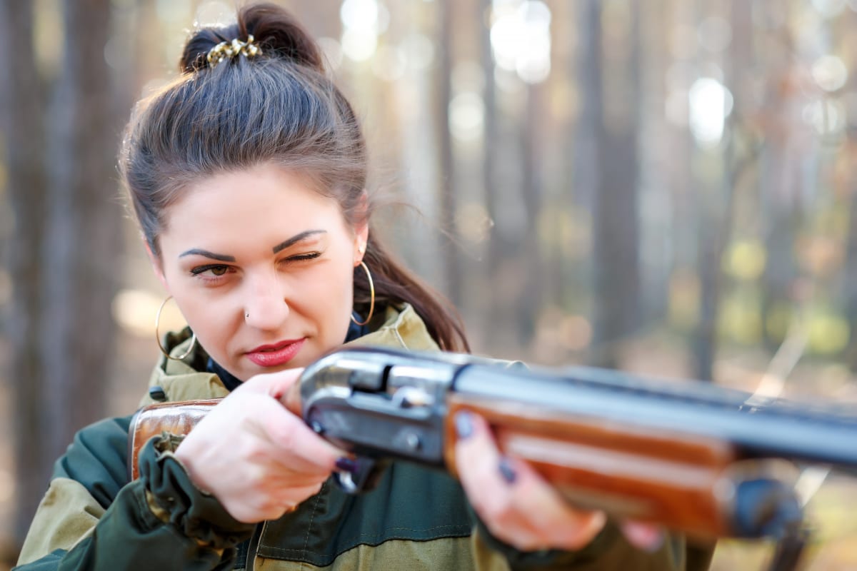 A woman shooting during clay pigeon shoot