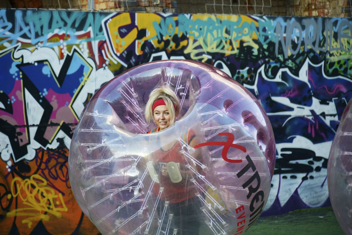 a happy hen party playing zorb football