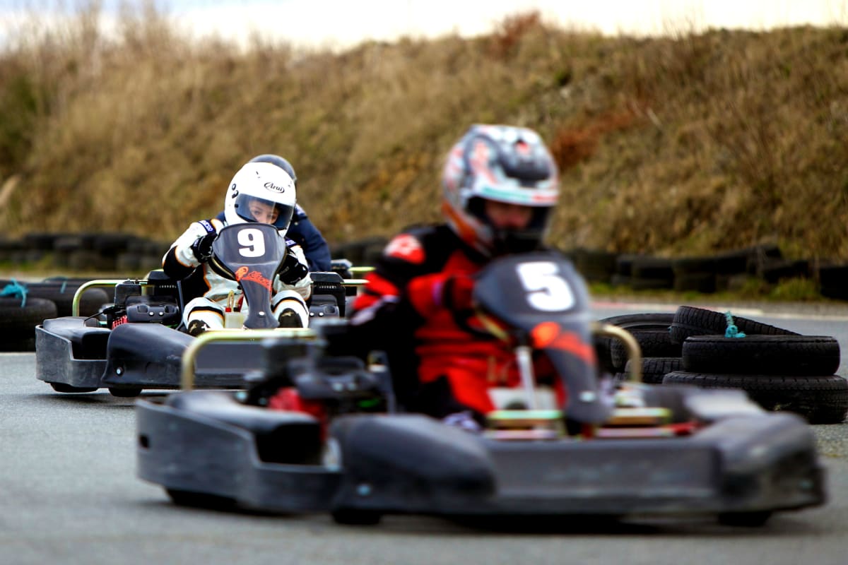 A man in a go kart racing around a track