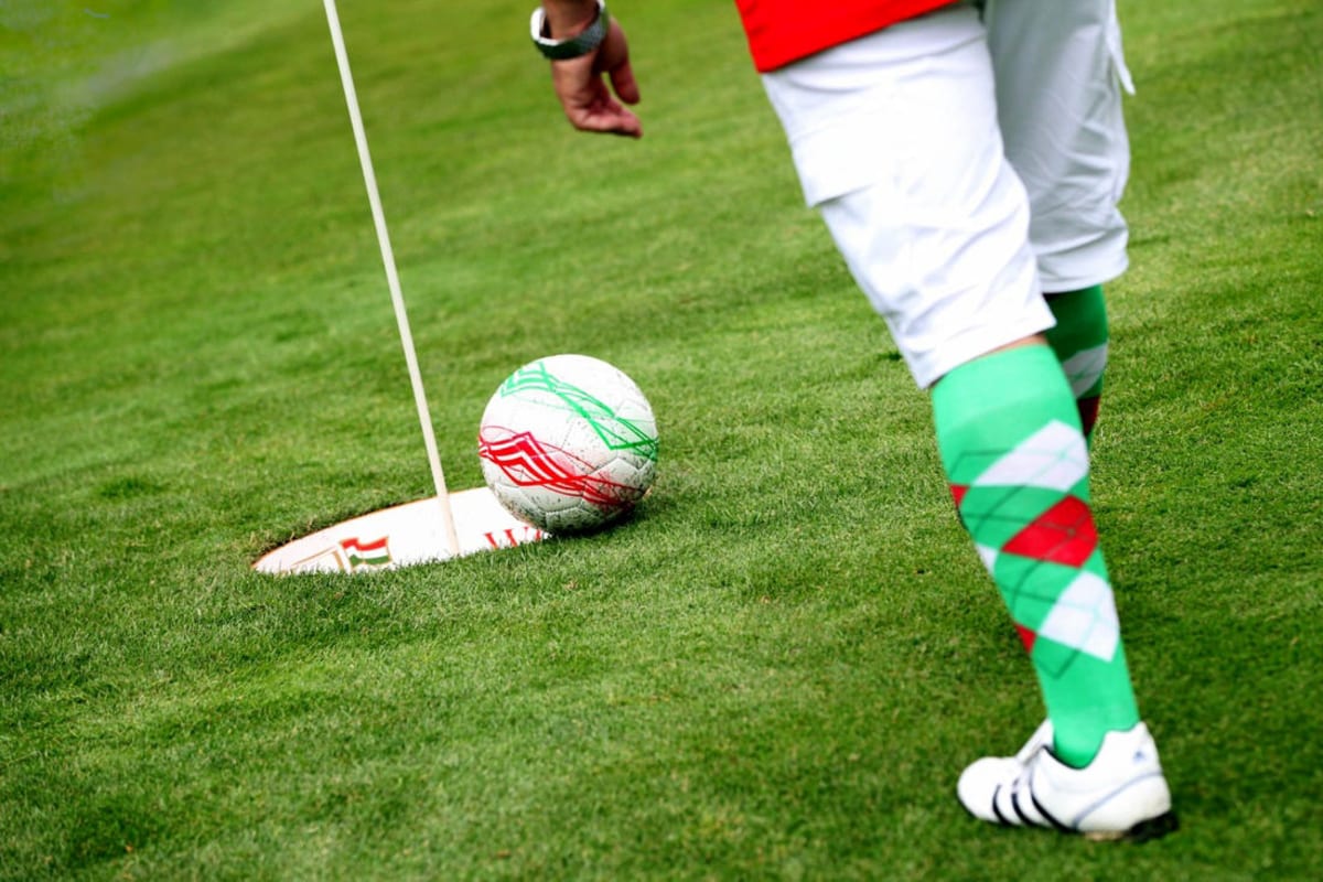A man playing footgolf