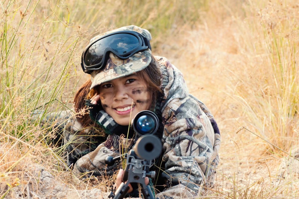 A hen playing airsoft