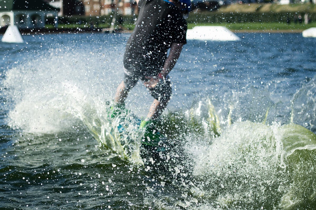 A person being pulled by a cable wakeboarding