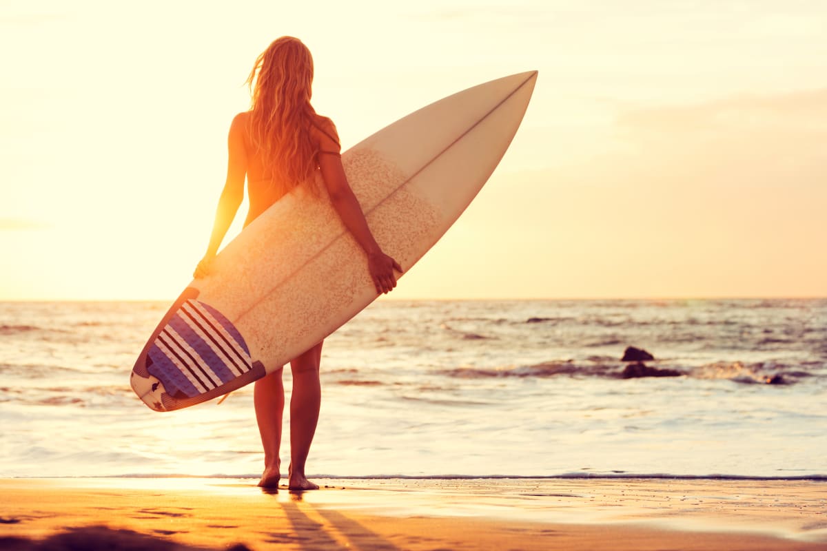 A female surfer on a beach