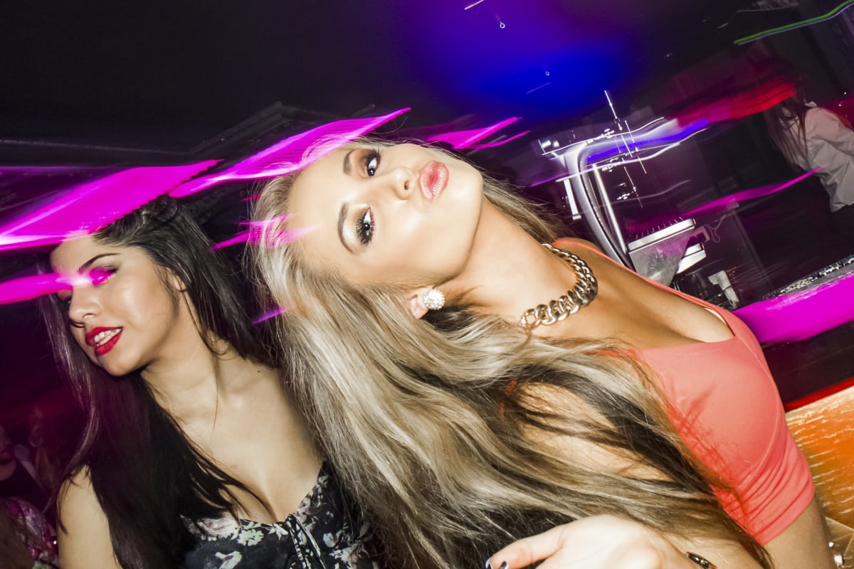 Two attractive girls having fun in a nightclub
