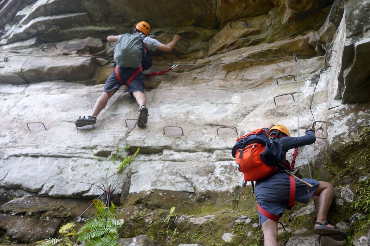 group of guys rock climbing