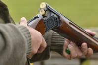 Man loading shot gun during clay pigeon event