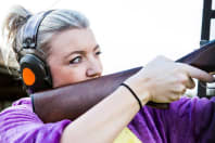 A woman on a hen party clay pigeon shooting