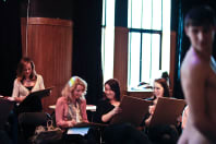 A laughing hen group enjoying male life drawing